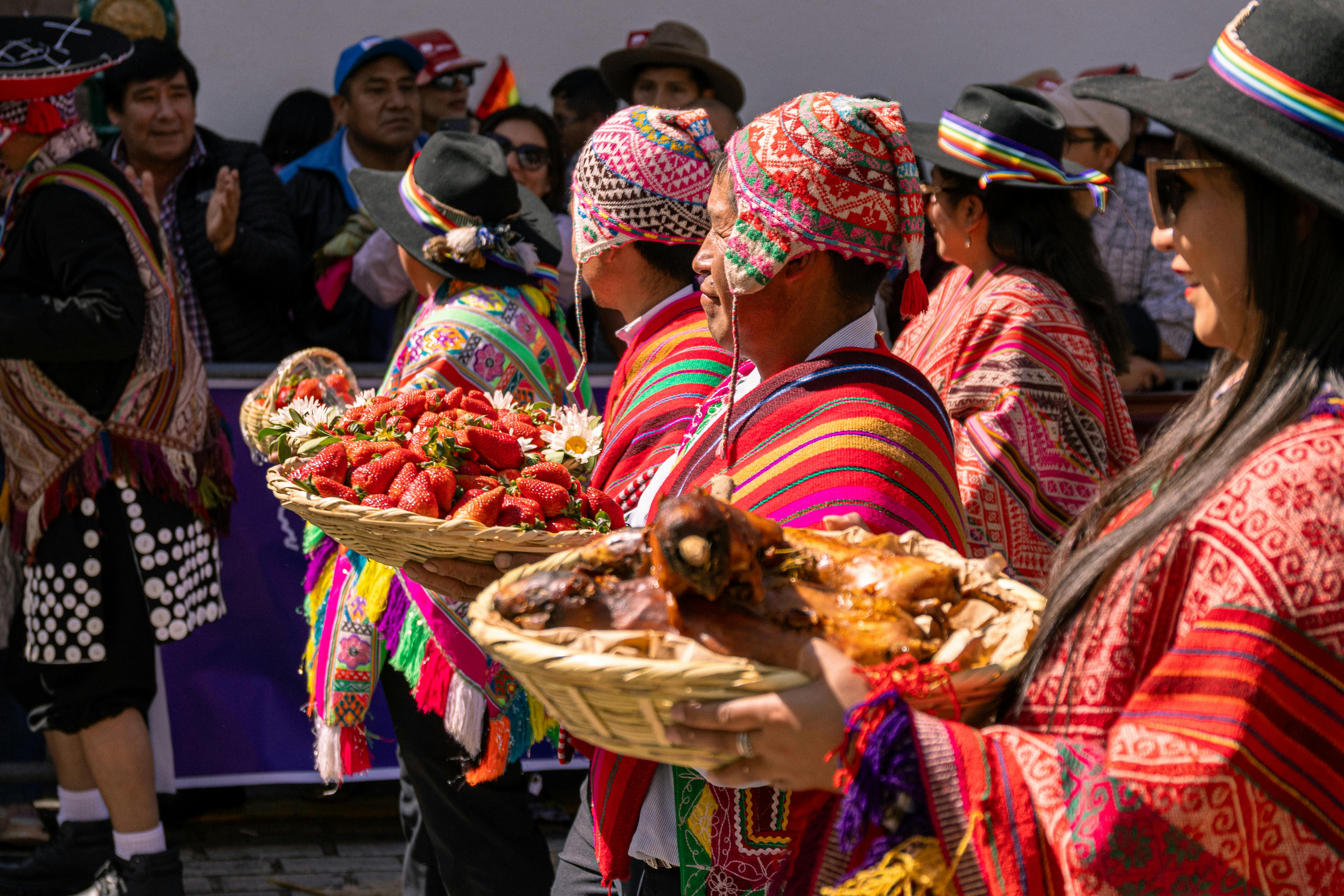 Indigenous People in Traditional Clothing Holding Fruit Baskets